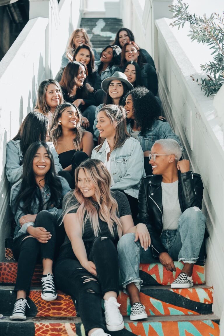 group of people sitting on gray concrete stairs